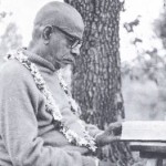 Srila Prabhupada, reading beneath a willow tree at the original New Vrindaban farm, 1969